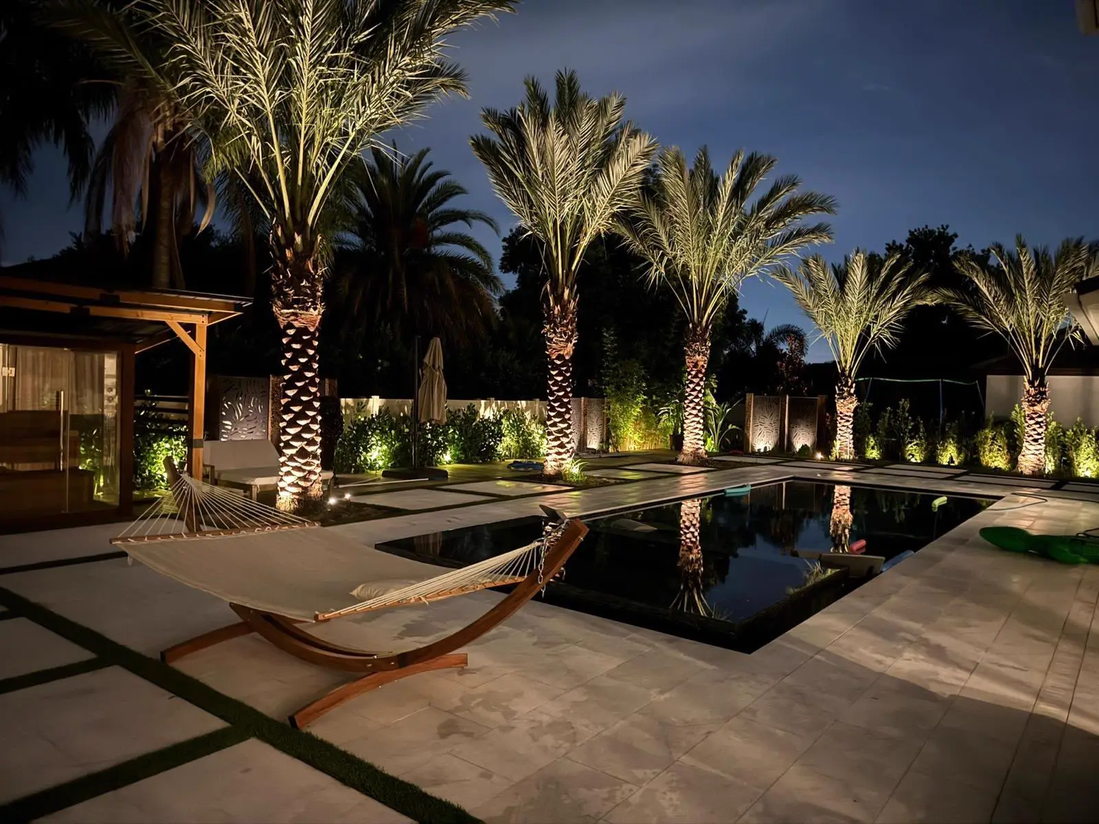 Palm-Lit Pool & Hammock